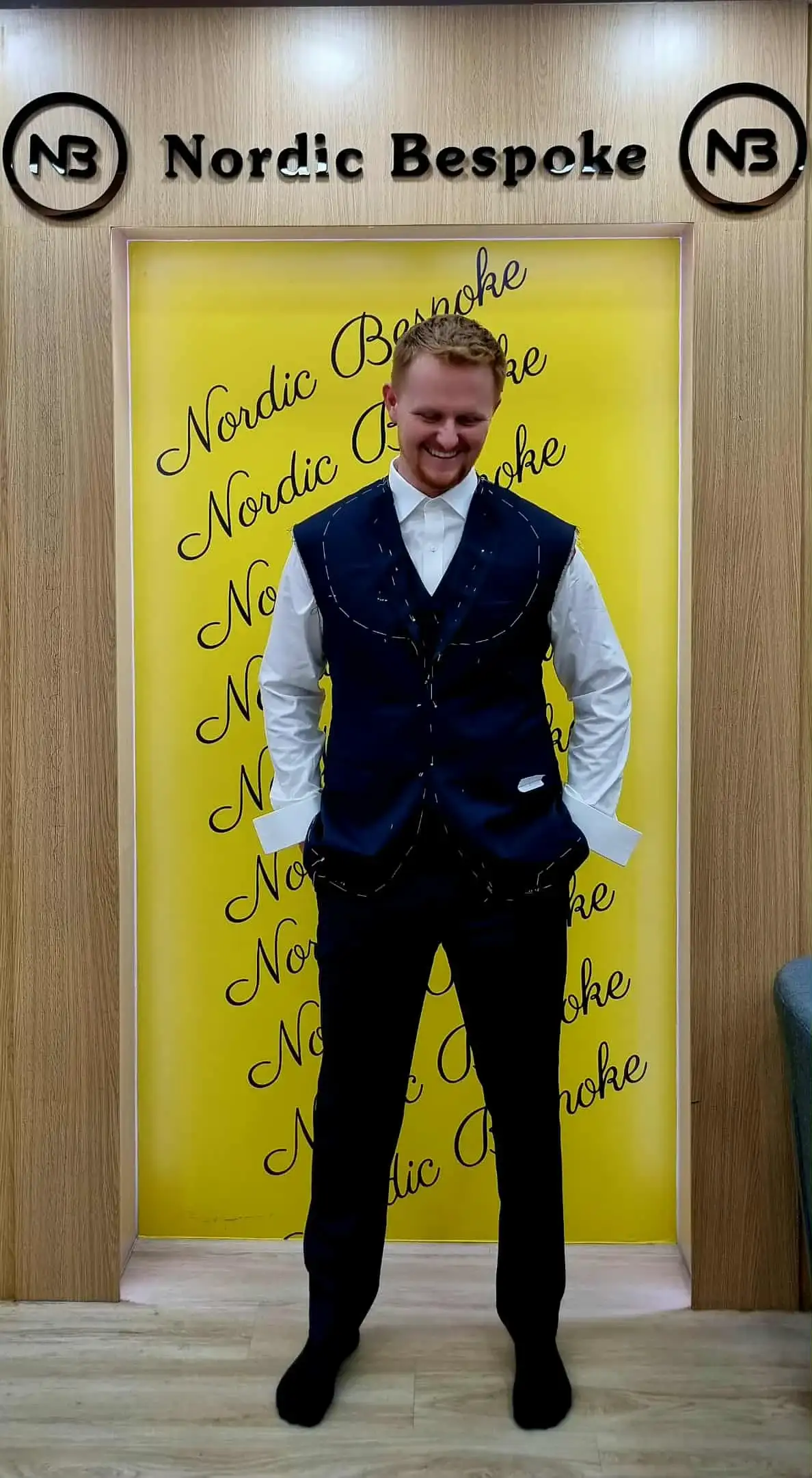 Male client wearing navy waistcoat and white shirt bespoke outfit